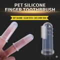 Clear soft silicone pet finger toothbrush placed on index finger for cat and dog oral care
