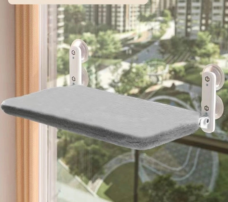 Foldable grey plush cat window hammock mounted on glass window with heavy duty suction cups
