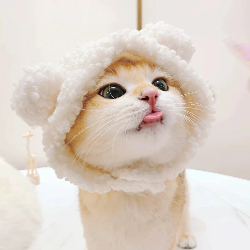cat wearing a fluffy white Snowball Snugg plush bear ear costume hat