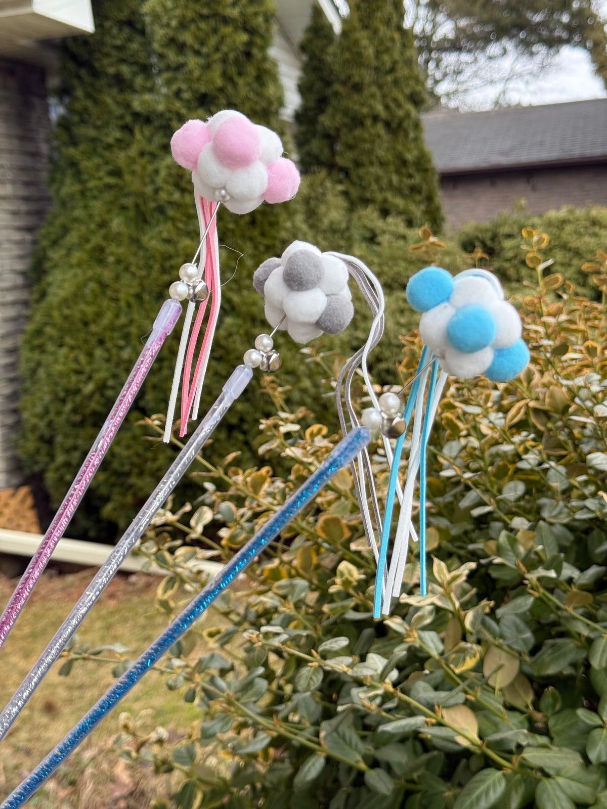 Assorted cloud fairy wand cat teaser toys in pink, grey, and blue with ribbons and bells
